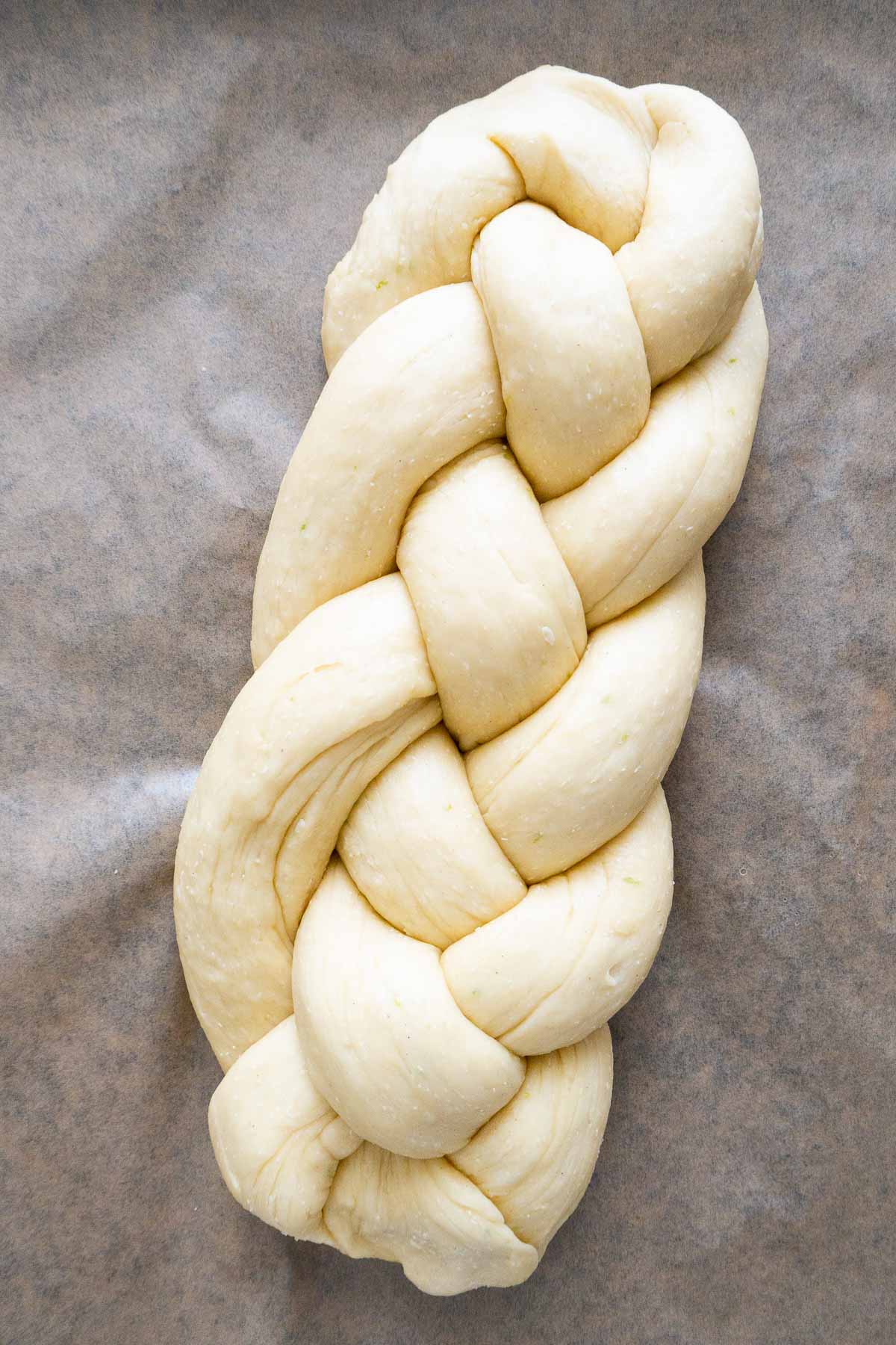 Un Hefezopf avant cuisson sur du papier sulfurisé.